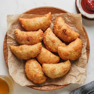 sri lankan patties on a plate with ketchup.