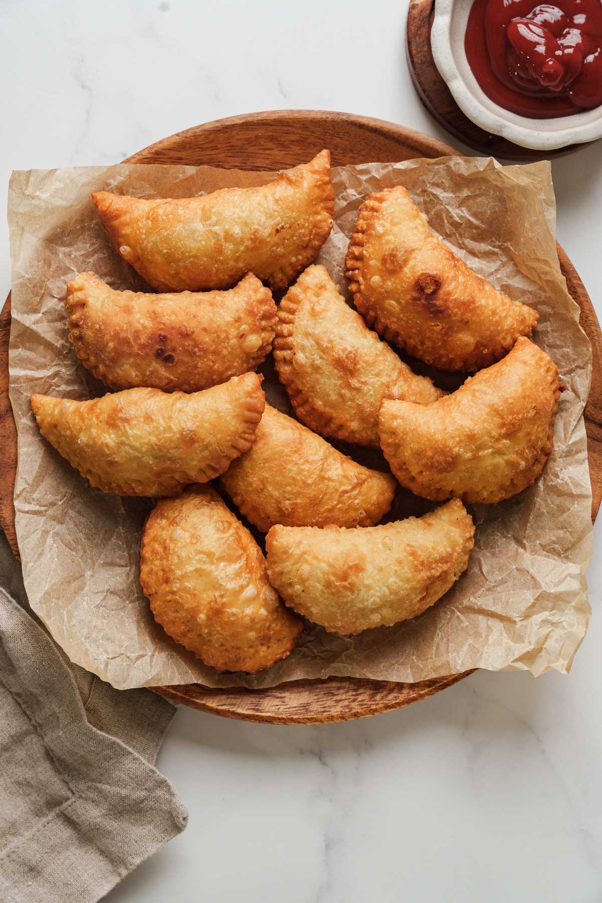 sri lankan patties on a plate with ketchup.