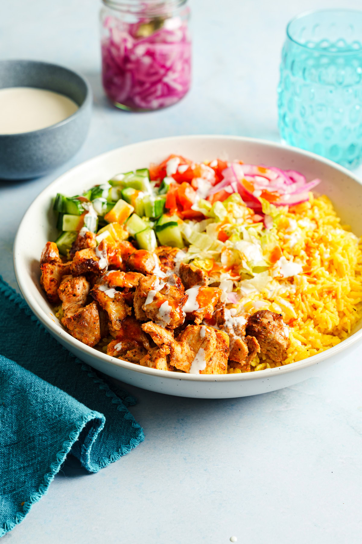 halal cart chicken and rice bowl on a blue background.