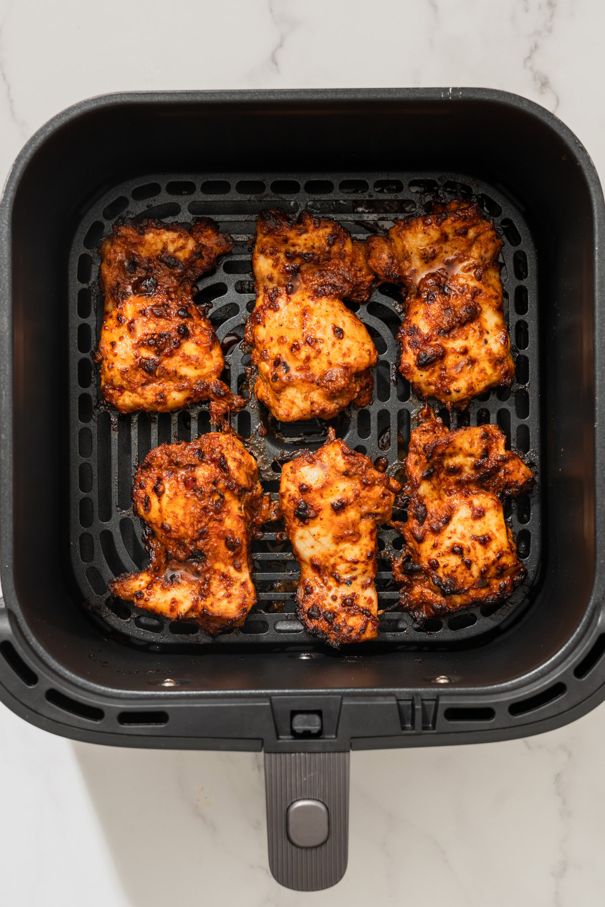 air fried harissa chicken in the air fryer.