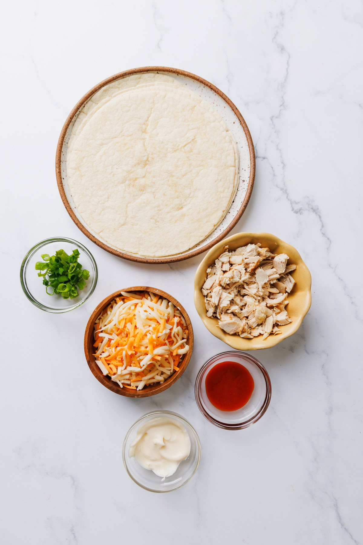 ingredients for air fryer chicken quesadillas on a white background.