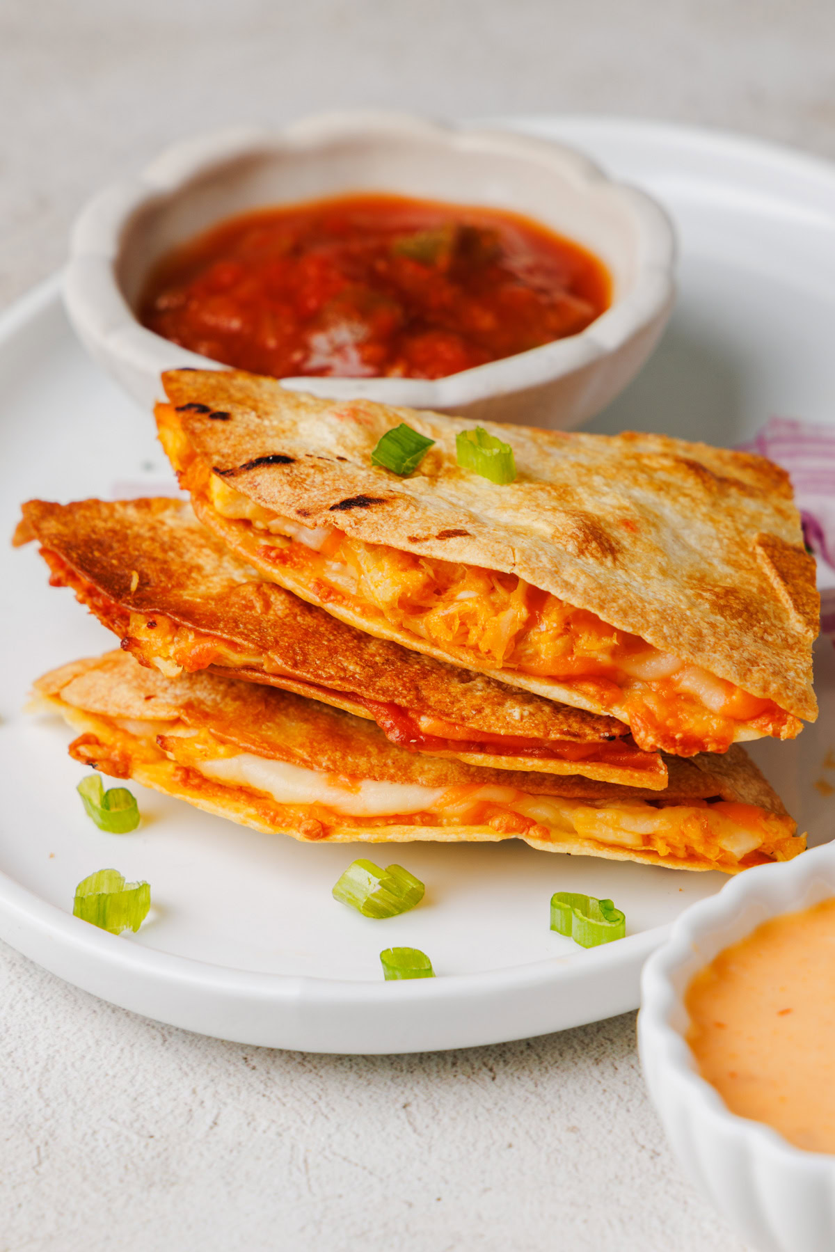 stacked air fryer quesadillas on a plate.