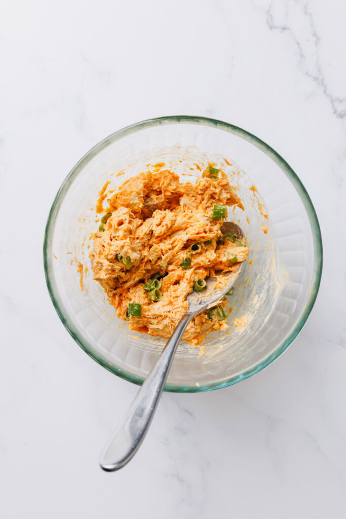 A bowl of chicken filling for quesadillas.