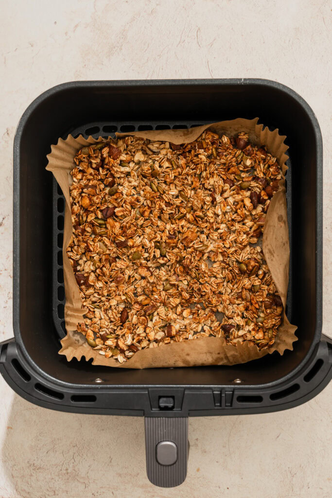 air fried granola in the air fryer basket.