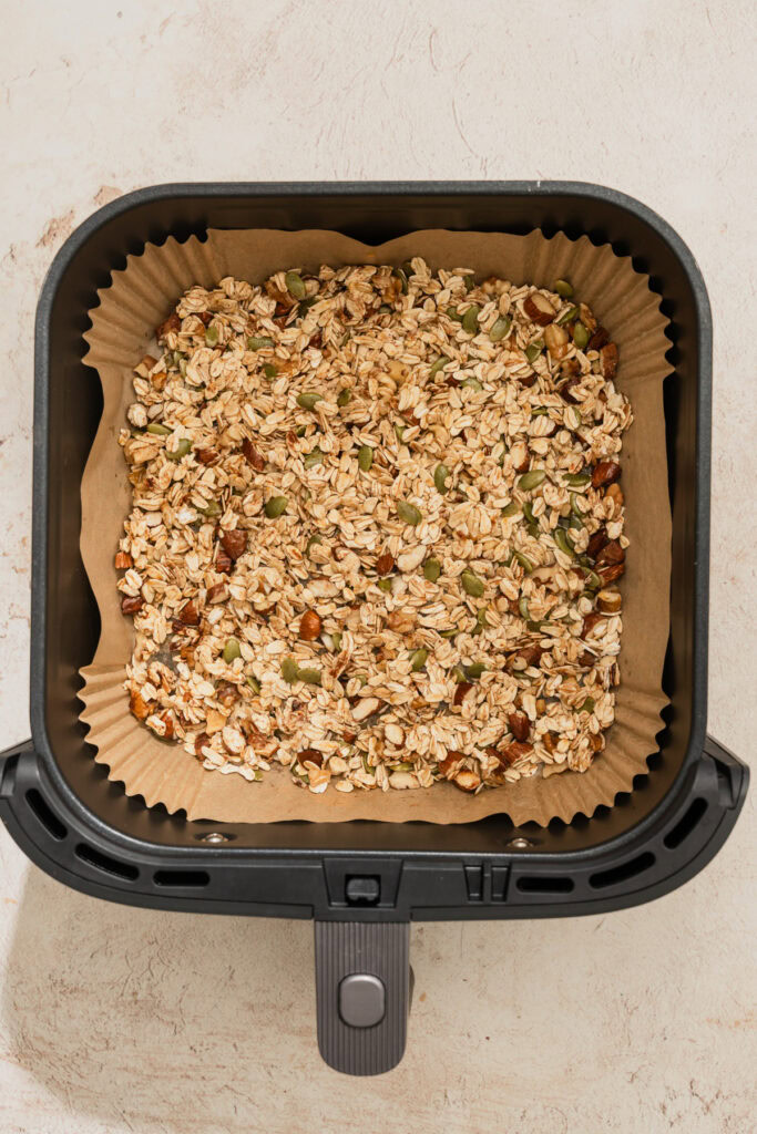 granola ingredients mixed and placed in the air fryer.