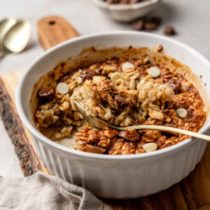 Air fryer baked oats topped with chocolate chips with a spoon.
