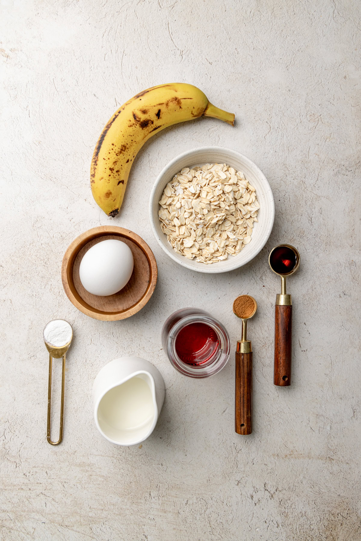 Banana, oats, milk, and spices for healthy breakfast ingredients.
