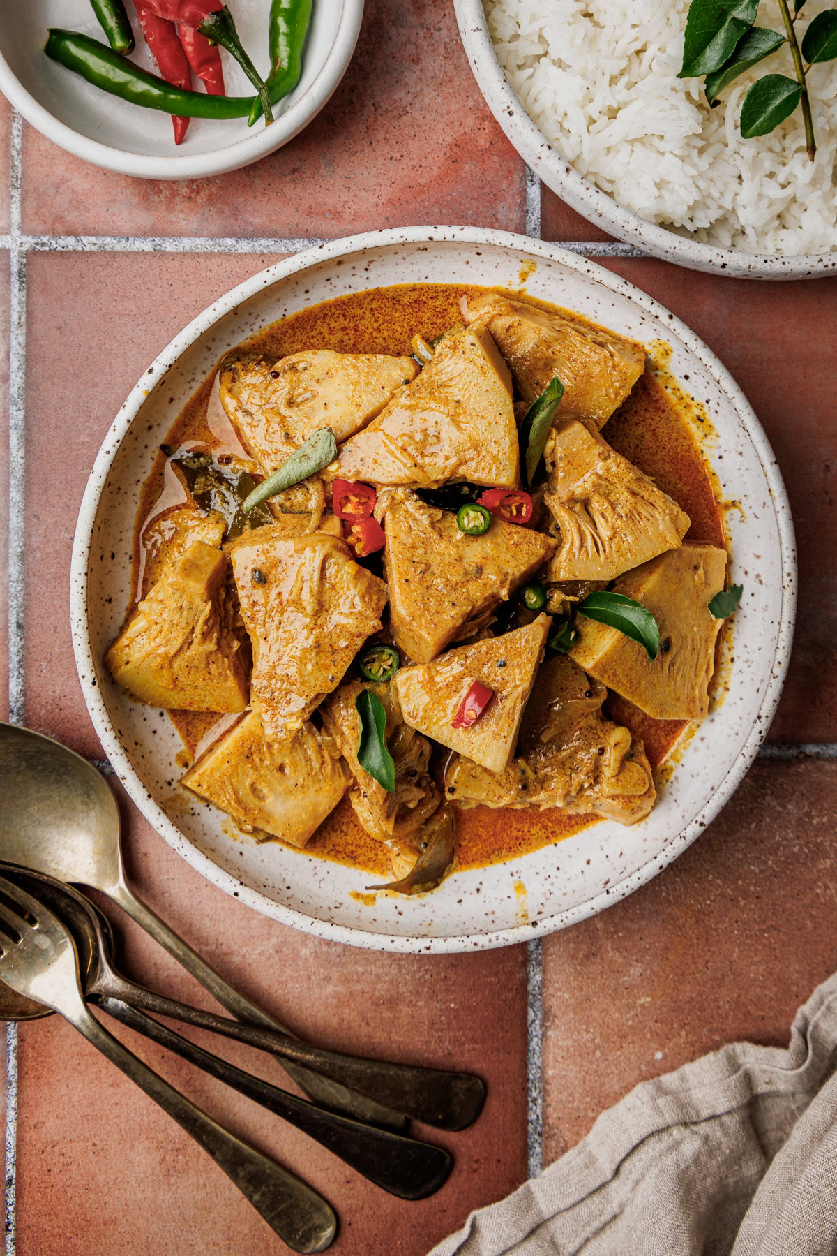 Sri Lankan green jackfruit curry in a pot with thick coconut milk gravy.